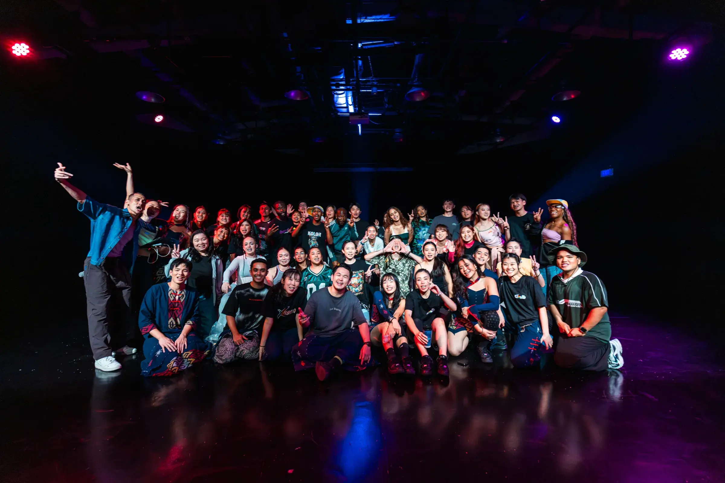 The full ACE 2025 cast banked in rows across the stage for a group photograph.