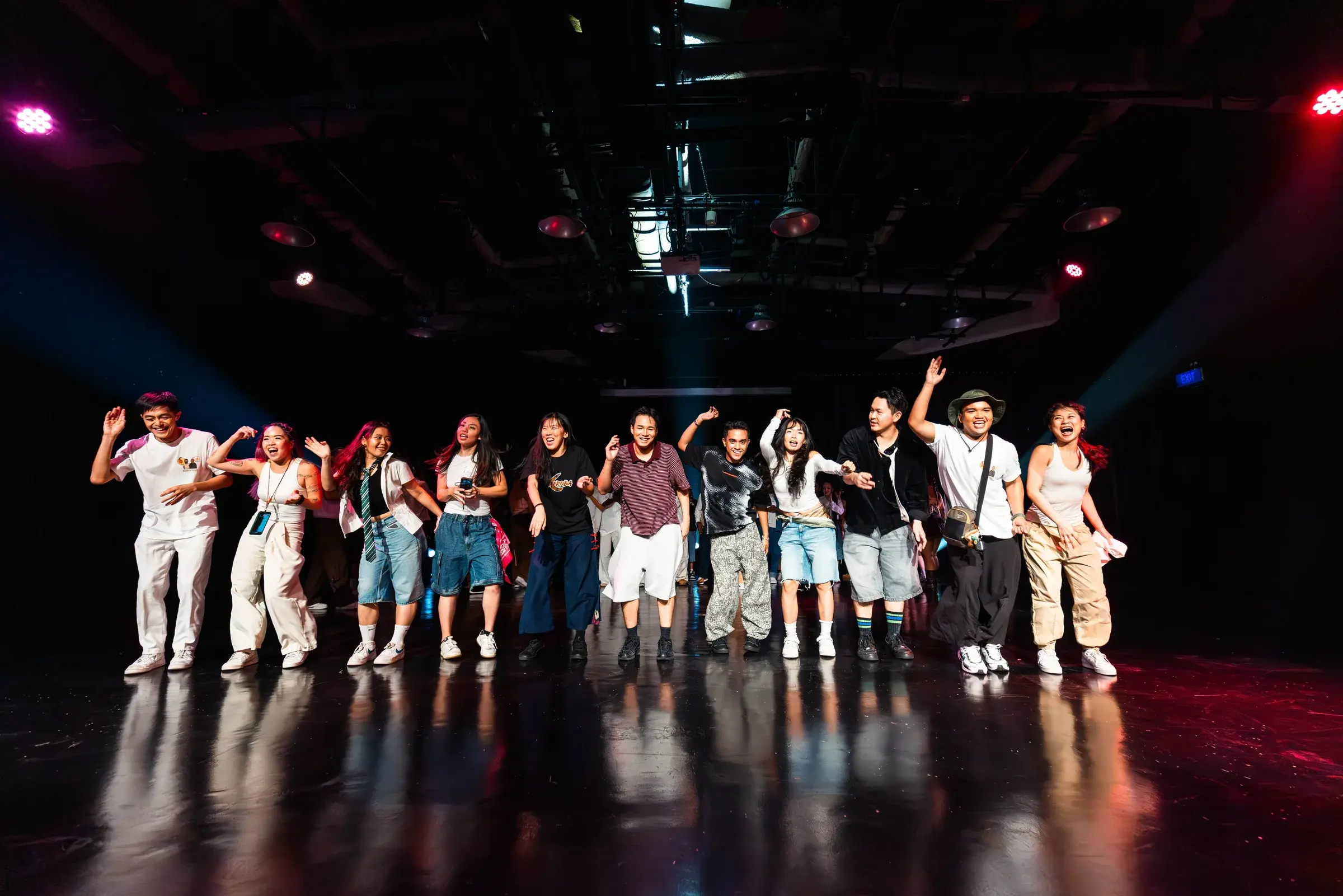 The whole cast walks downstage together with arms raised at the end of the show.